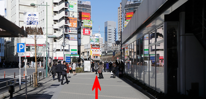 After leaving the West Exit, turn right and head towards a large pedestrian crossing.